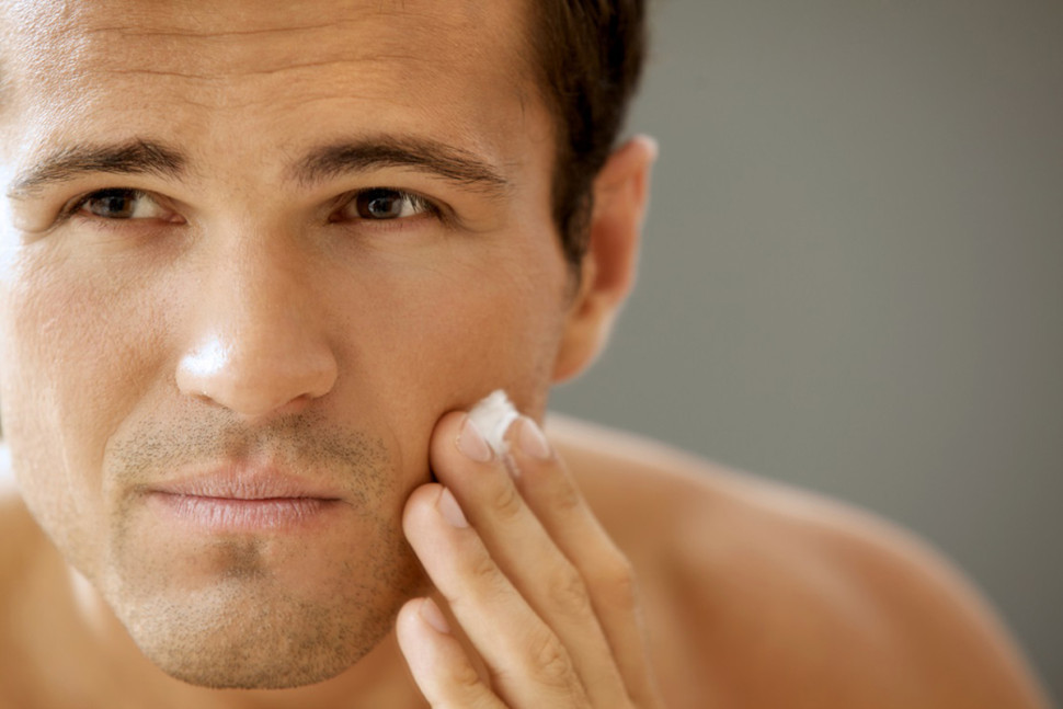 Close-up of young man applying shaving cream